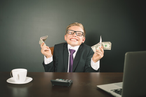 A boy holding some bills.