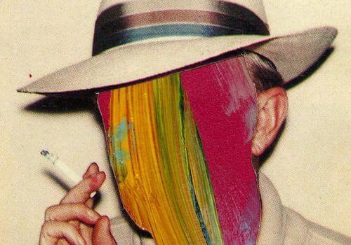 a man in a hat smoking with a colorful painted face