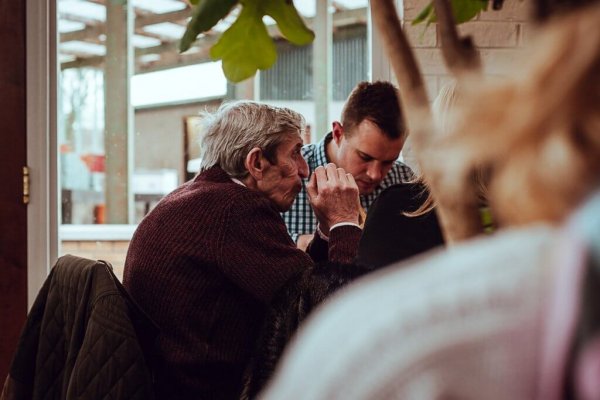 a son and elder father eating together
