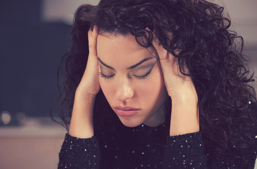 an upset, anxious woman with a headache