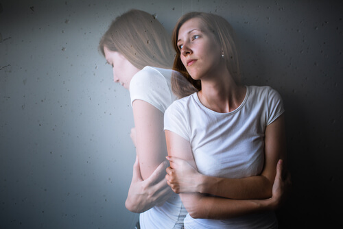 a woman crossing her arms in pain