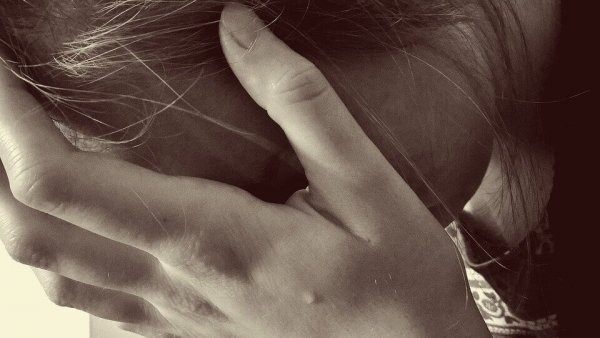 a woman crying into her hands