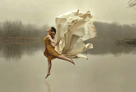a woman dancing freely on a lake