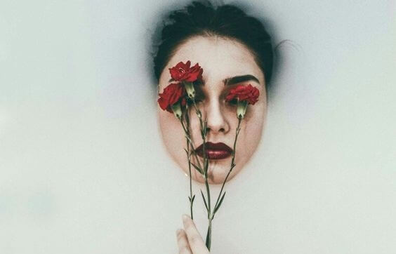 a woman with roses on her eyes