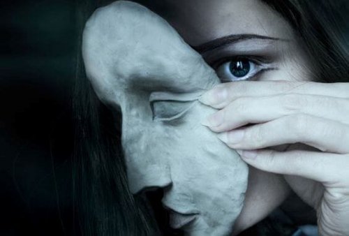 a woman removing a mask