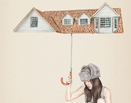 a woman holding an umbrella shaped like a house
