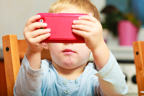 a baby playing with a cell phone