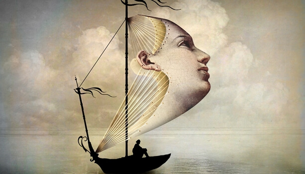 A boat has a giant face as a sail.