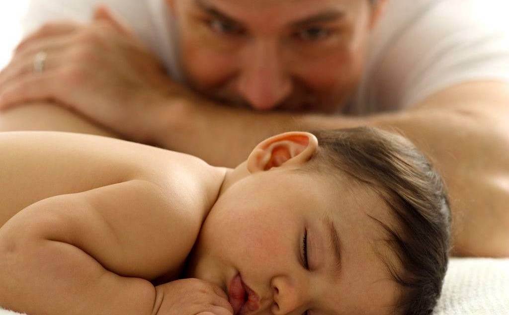 Father looking lovingly at his baby.