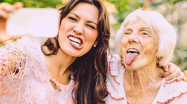 an older woman and a young woman taking a selfie
