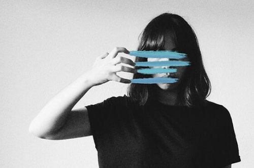 a woman with her face covered up by blue lines