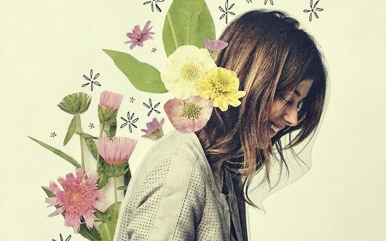 A happy woman has flowers on her back.