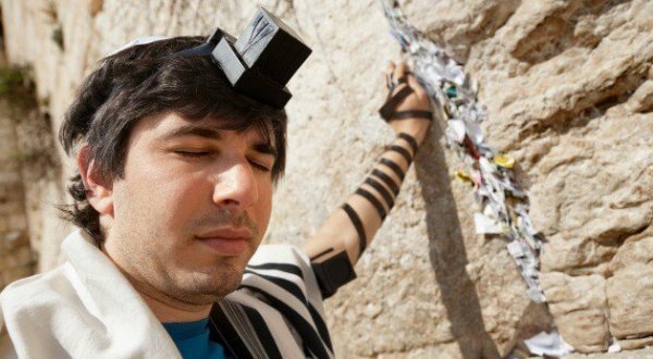 a man at the wailing wall of Jerusalem