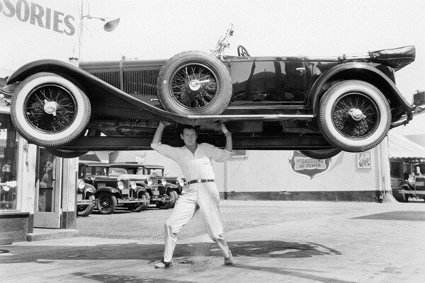 a man lifting a car