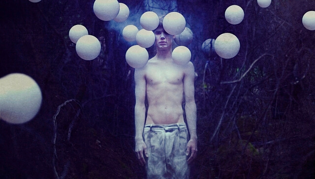 man dealing with sadness in the forest