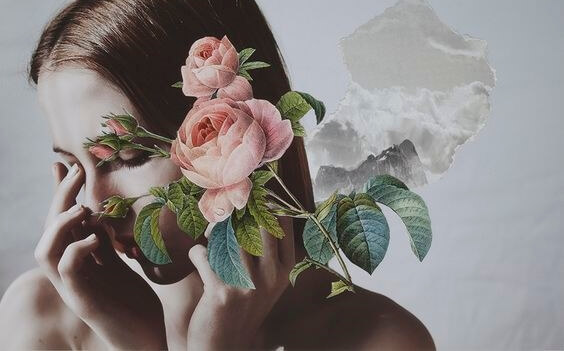 A woman's face covered by flowers.
