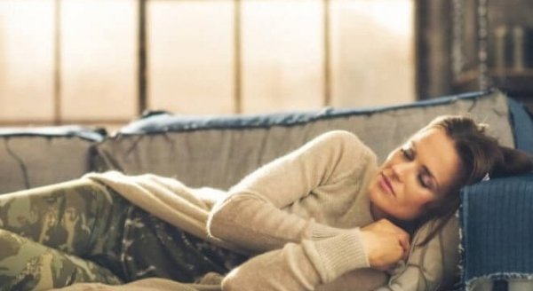 a woman sleeping on the couch with somniloquy