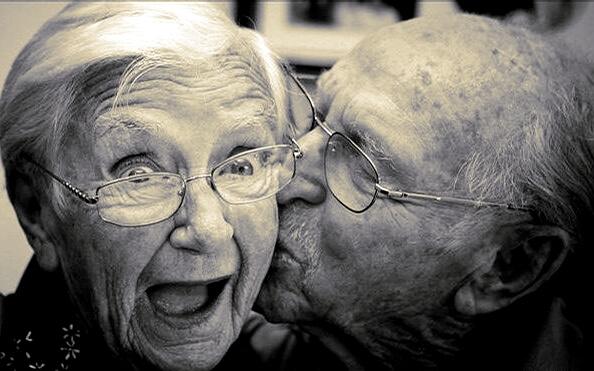 an old man kissing his wife