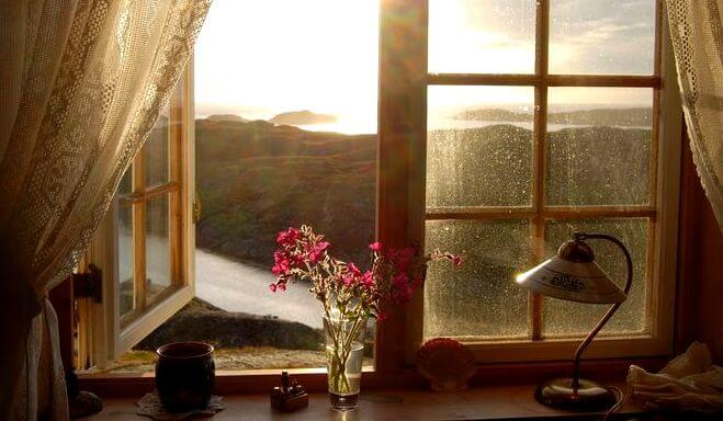 An open window showing a beautiful landscape.