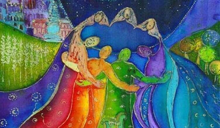 People in a circle creating a rainbow.