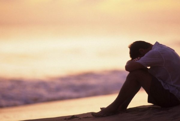 A sad man on the beach.