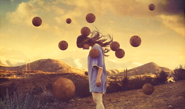 Sad woman surrounded by floating balls.