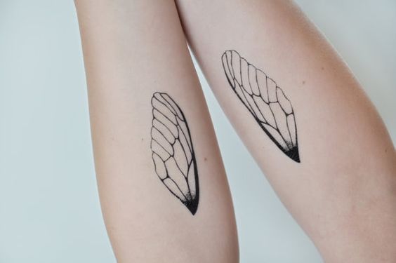 Two wings tattooed on legs.