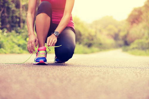 a runner tying her shoes