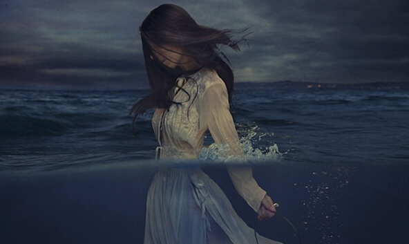 woman walking in the ocean