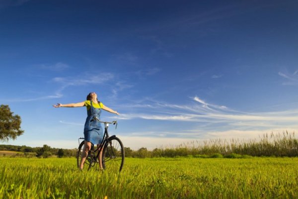 Biking free in a green field.