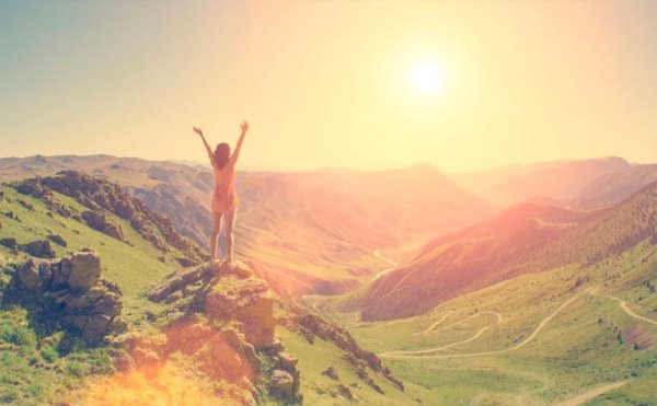woman on a mountain triumphing over her circumstances
