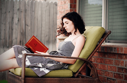 A woman reading outside.