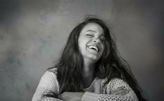 A happy woman laughing.