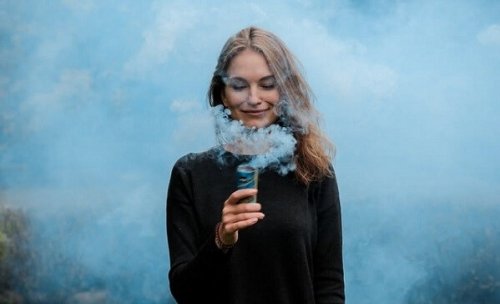 a woman smiling, surrounded by smoke