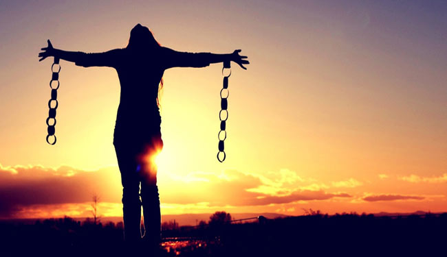 Woman with her arms stretched and chains hanging from them, symbolizing the subconsciou