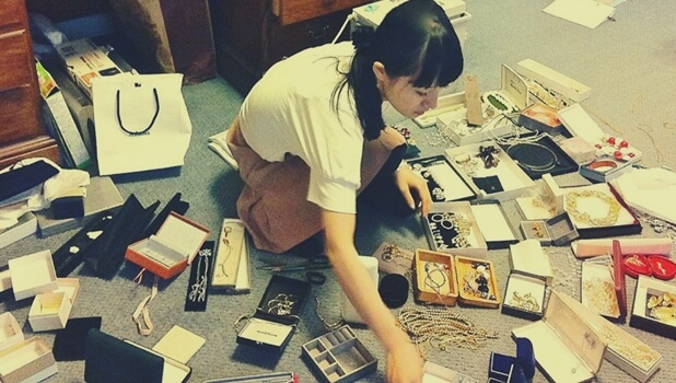 A woman with a lot of jewelry boxes.