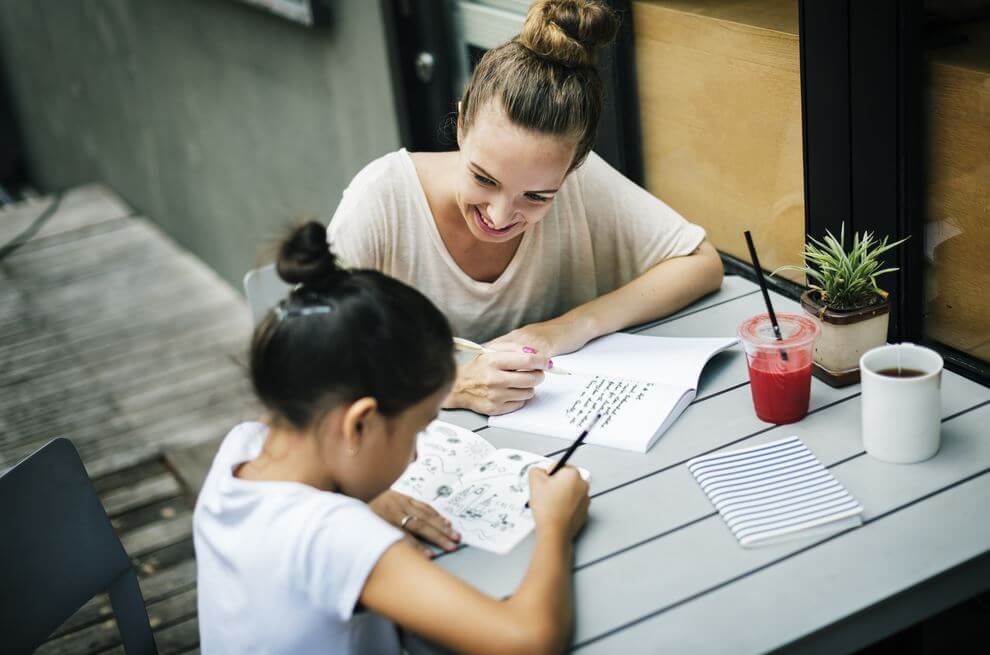 A mother and daughter are doing homework together.