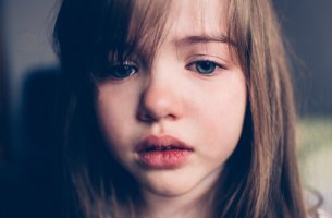 A sad little girl is crying.