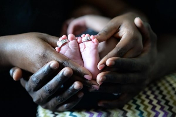 Hands round baby's feet