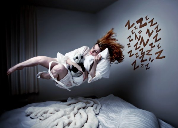 A woman flying over her bed in recurring nightmares.