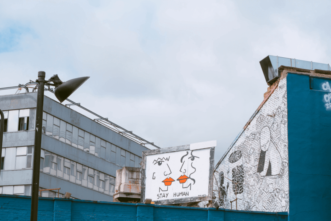 A billboard "STAY HUMAN"