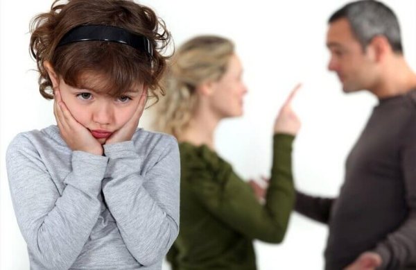 An upset child with arguing parents
