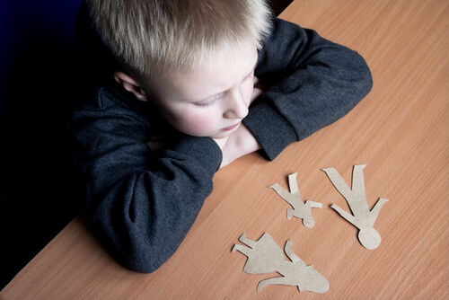 an upset little boy thinking about his parents