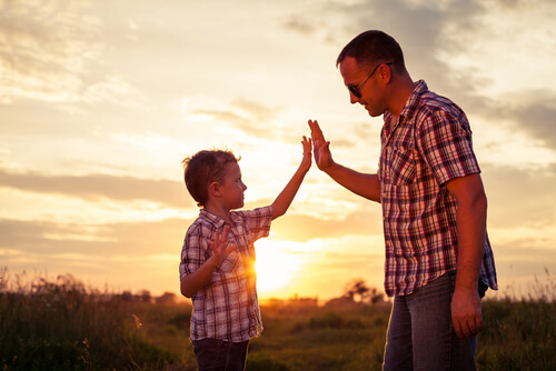 A father and son are in a field.