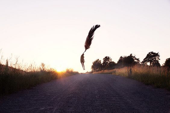Figure flying clinging to a feather.
