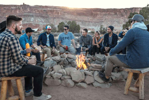 friends enjoying time around a bonfire: effective social skills