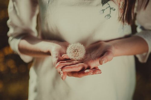 Girl holding a dandelion.