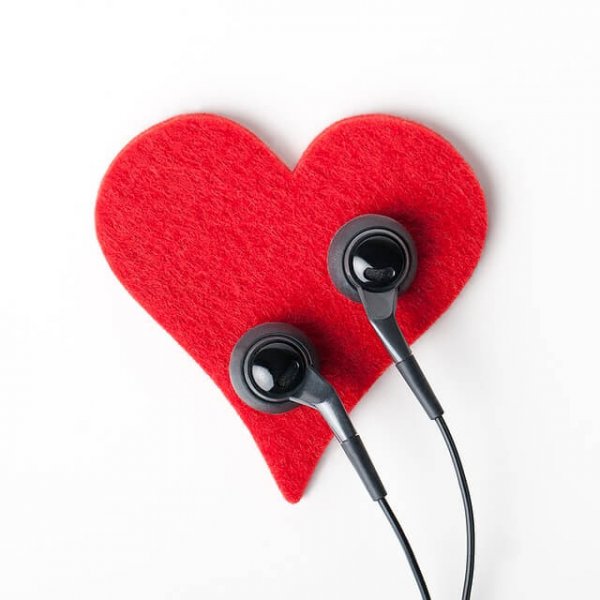 Listening to the heart: earbuds on a felt heart.