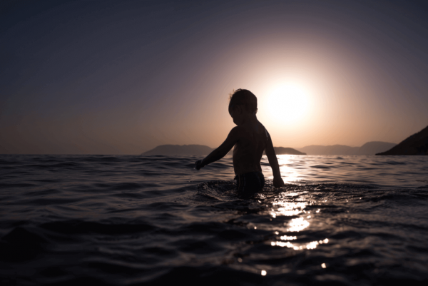 a boy swimming in the sea