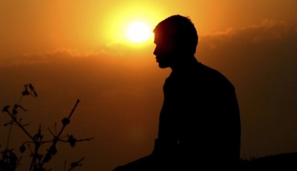 Honor as pictured by a silhouetted man in the sunset.